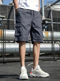 Dark gray men cargo shorts with side pockets and drawstring waist, styled with white sneakers