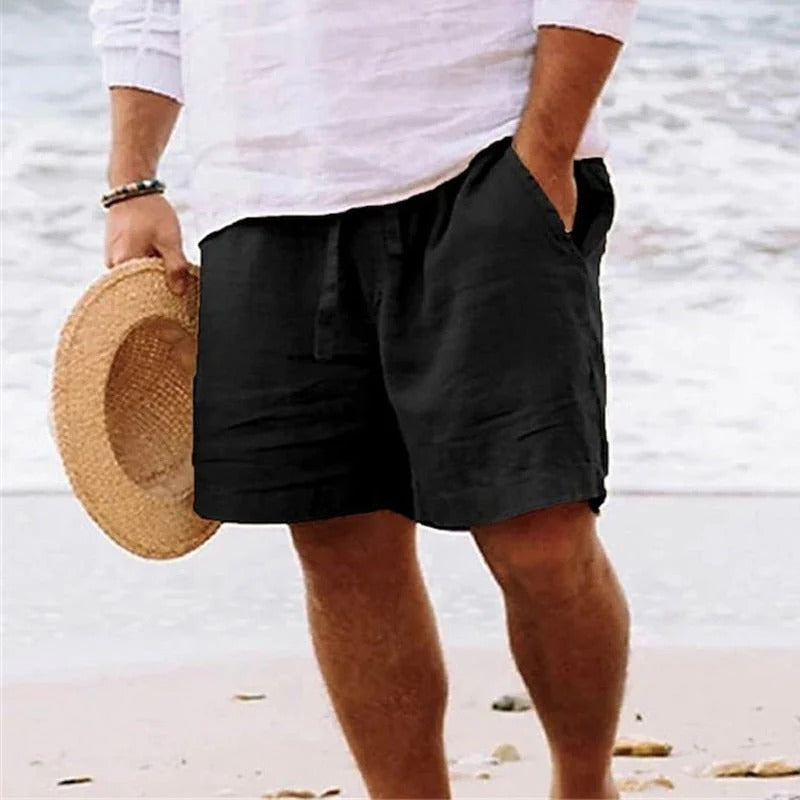Black knee length linen shorts with loose fit, drawstring front, and side pockets