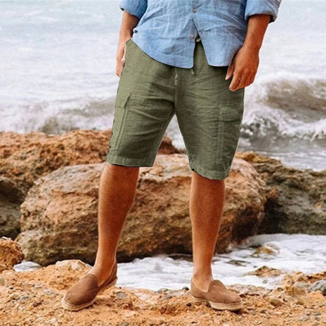 Men's olive green knee length shorts with relaxed fit, shown with a light blue shirt and loafers