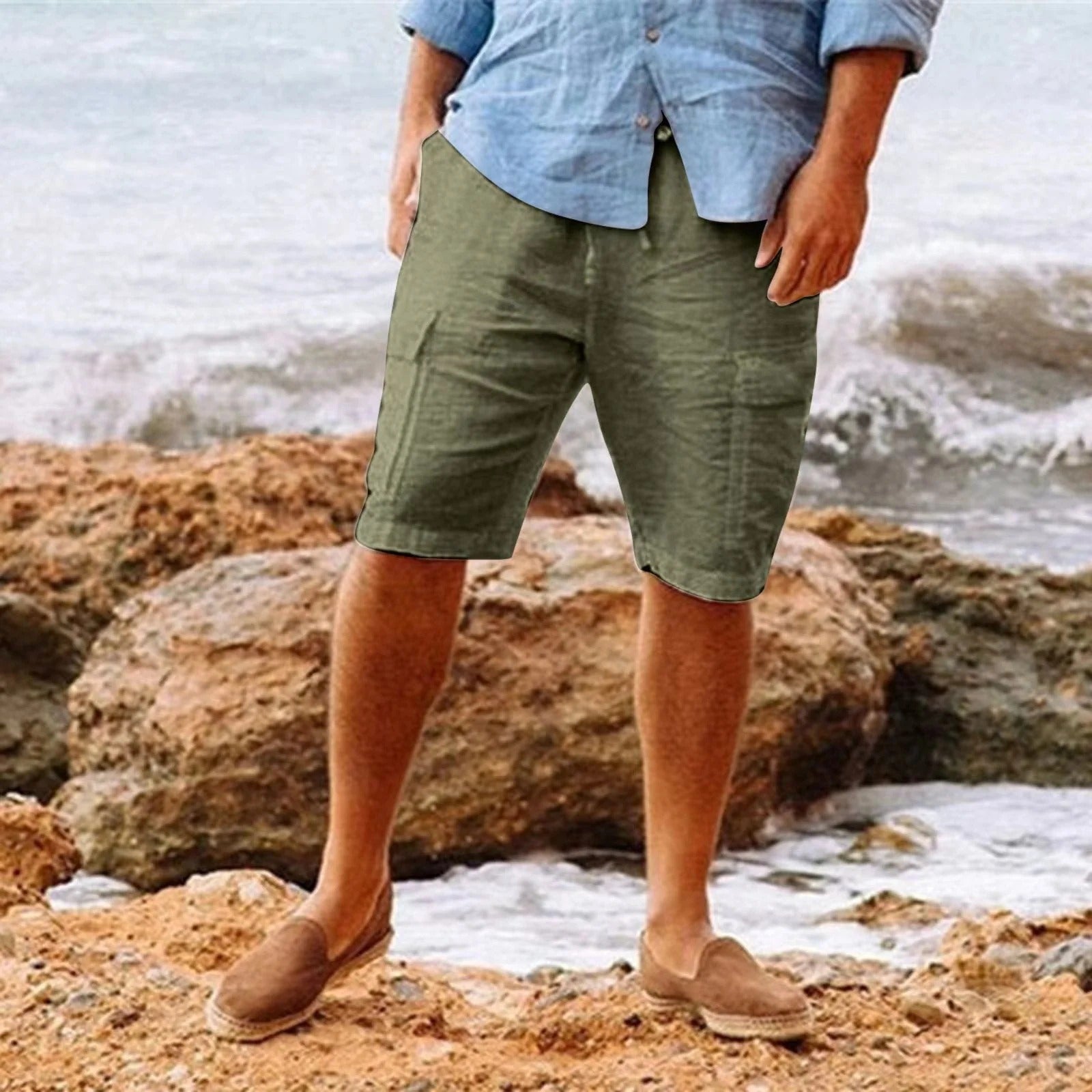 Men's olive green knee length shorts with relaxed fit, shown with a light blue shirt and loafers
