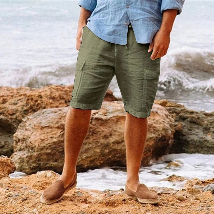 Men's olive green knee length shorts with relaxed fit, shown with a light blue shirt and loafers