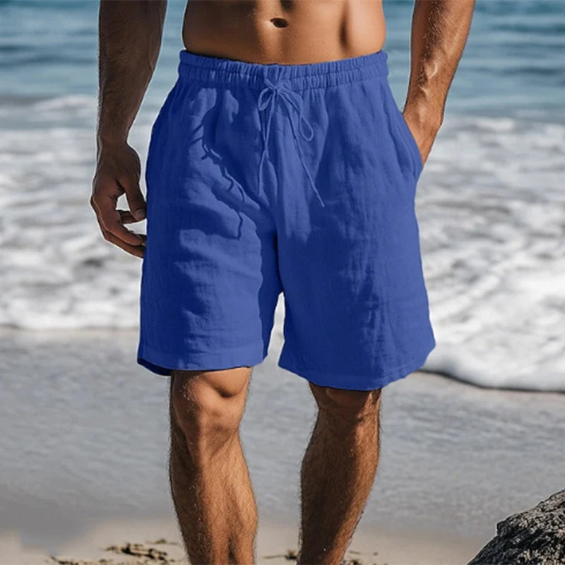 Royal blue drawstring beach shorts with soft cotton texture and side pockets