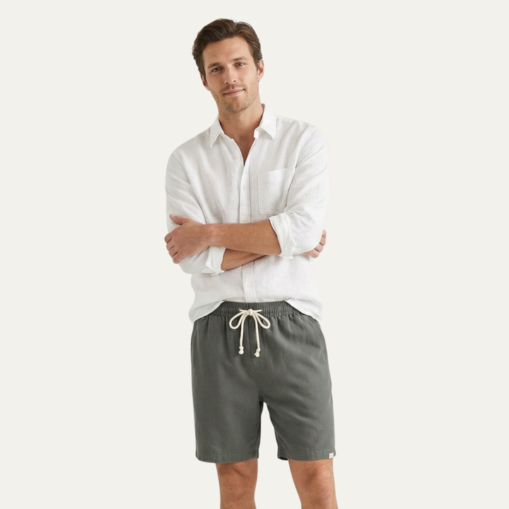Model wearing dark gray linen shorts with white shirt, casual men's summer shorts