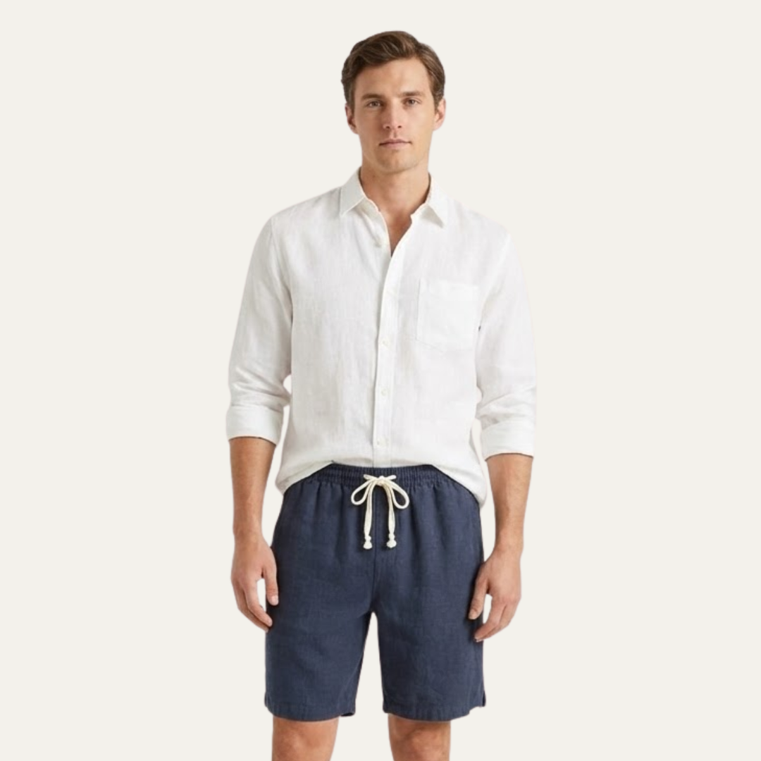 Model wearing navy drawstring linen shorts with a white shirt for a casual summer look