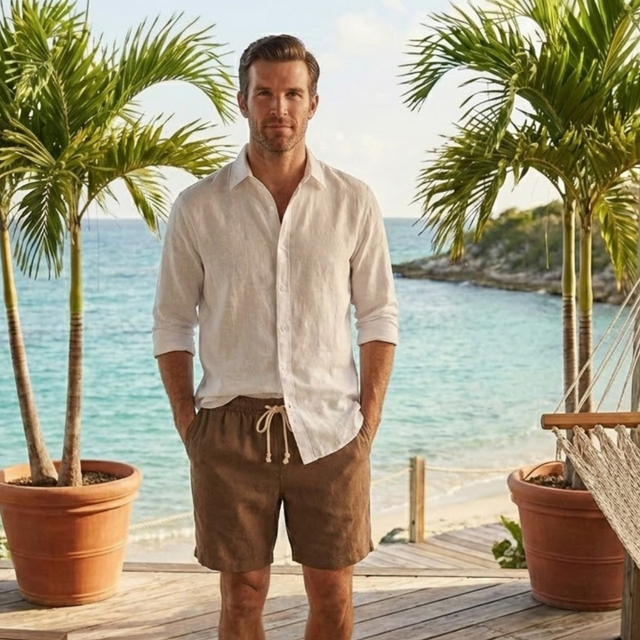 Brown drawstring linen shorts for men worn with a white shirt by the beach