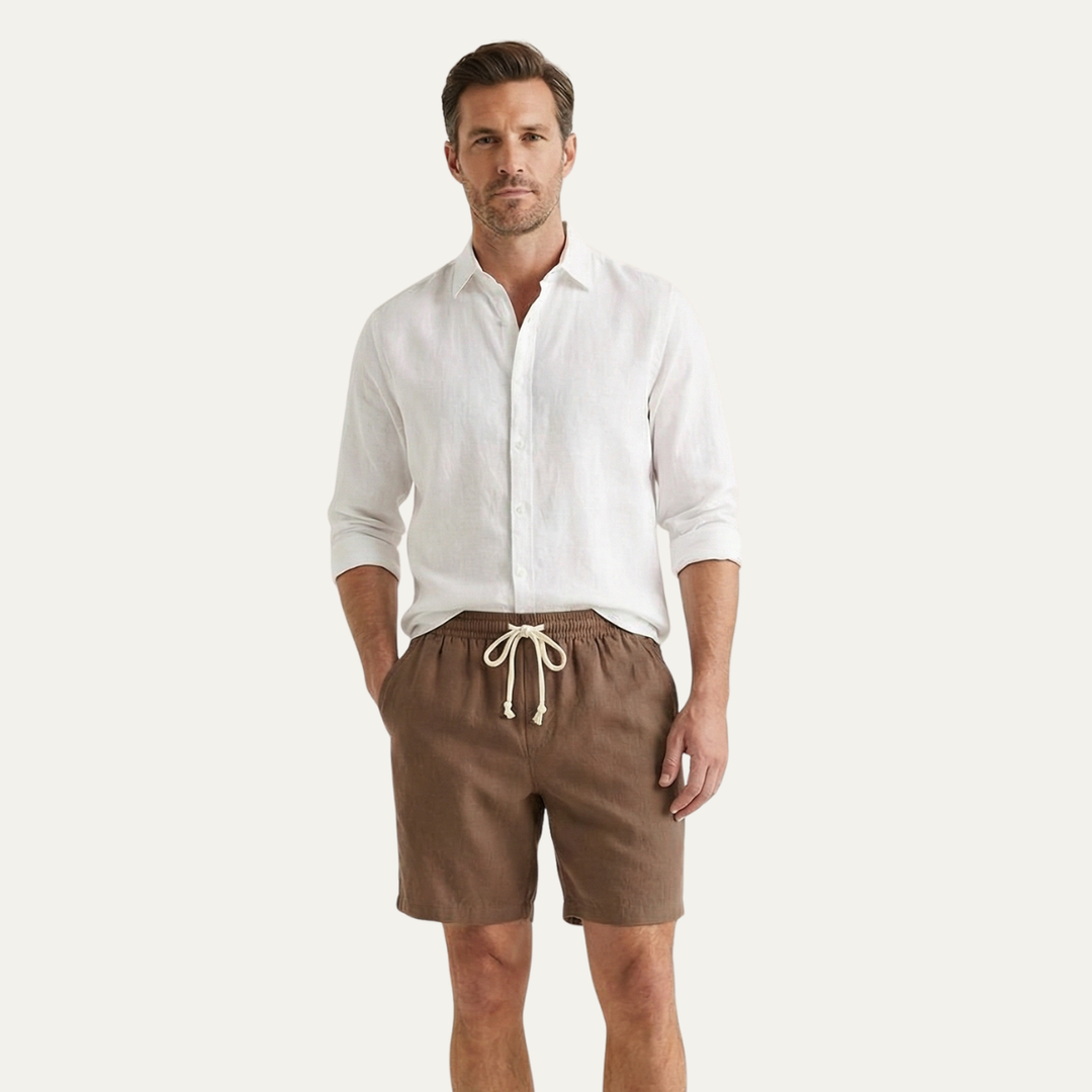 Model wearing brown summer linen shorts with white shirt, casual men's shorts