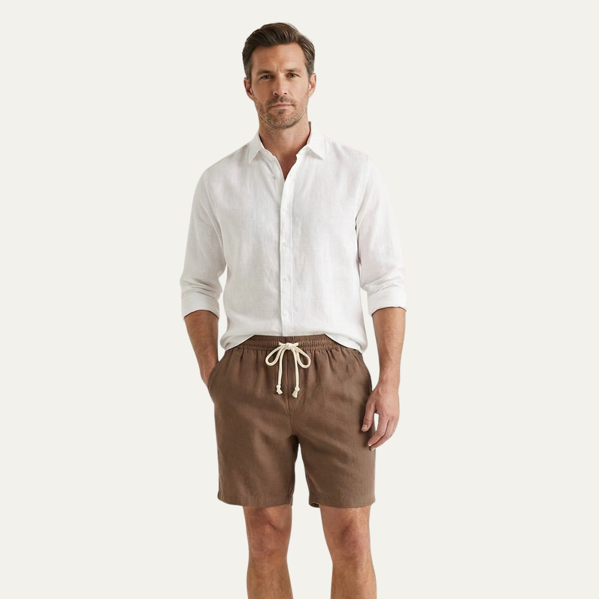 Model wearing brown summer linen shorts with white shirt, casual men's shorts