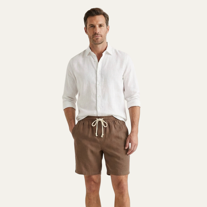 Model wearing brown summer linen shorts with white shirt, casual men's shorts