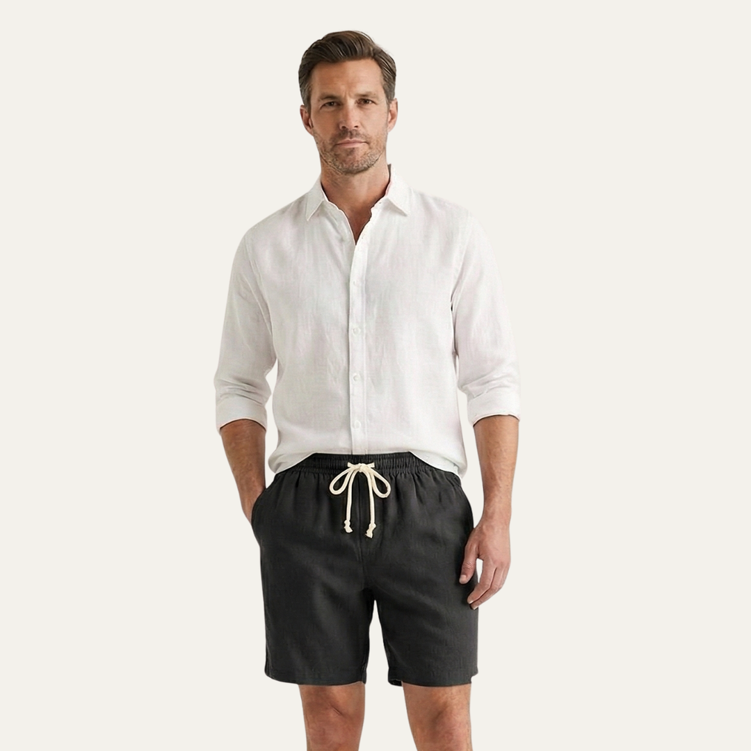 Model wearing black drawstring linen shorts with white shirt, men's casual summer shorts