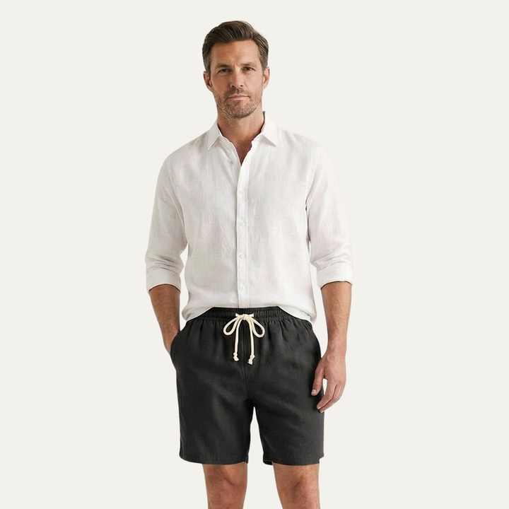 Model wearing black drawstring linen shorts with white shirt, men's casual summer shorts