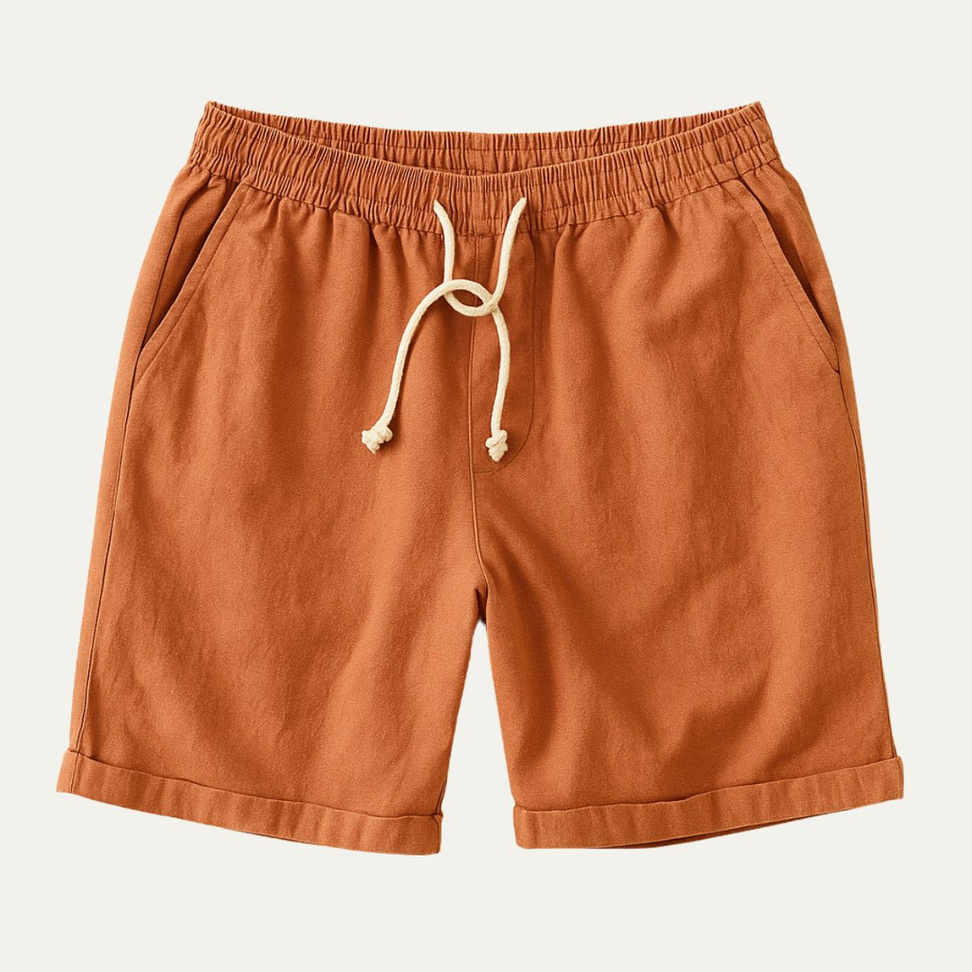 Orange men's linen shorts with rolled hems, drawstring waist, and relaxed summer style