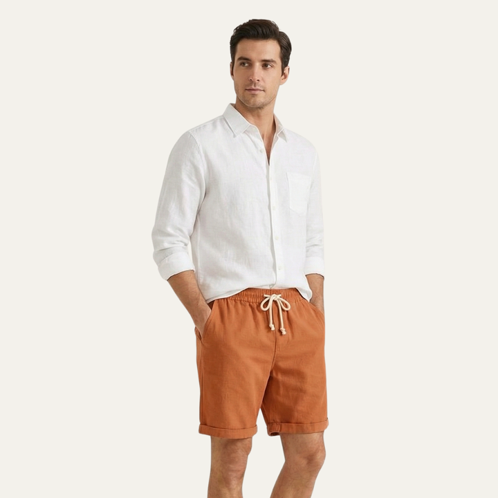 Model wearing orange drawstring linen shorts with white shirt, lightweight men's shorts