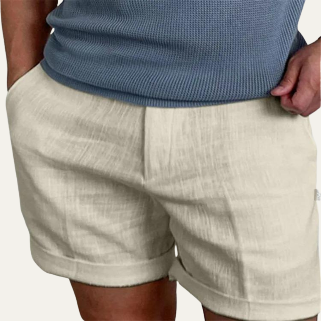 Light beige men summer linen shorts on model, relaxed fit with elastic waist and cuffed legs