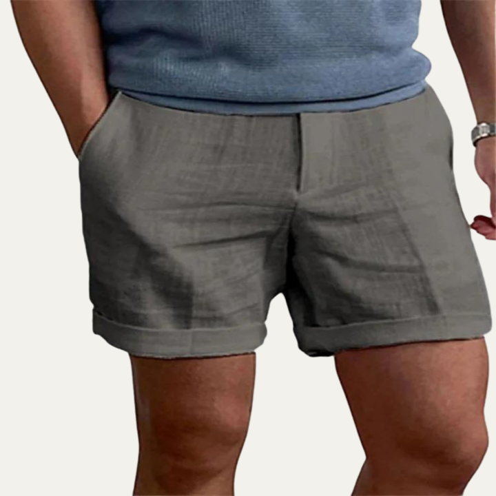 Gray men linen shorts with relaxed fit, front view showing elastic waist and cuffed hem