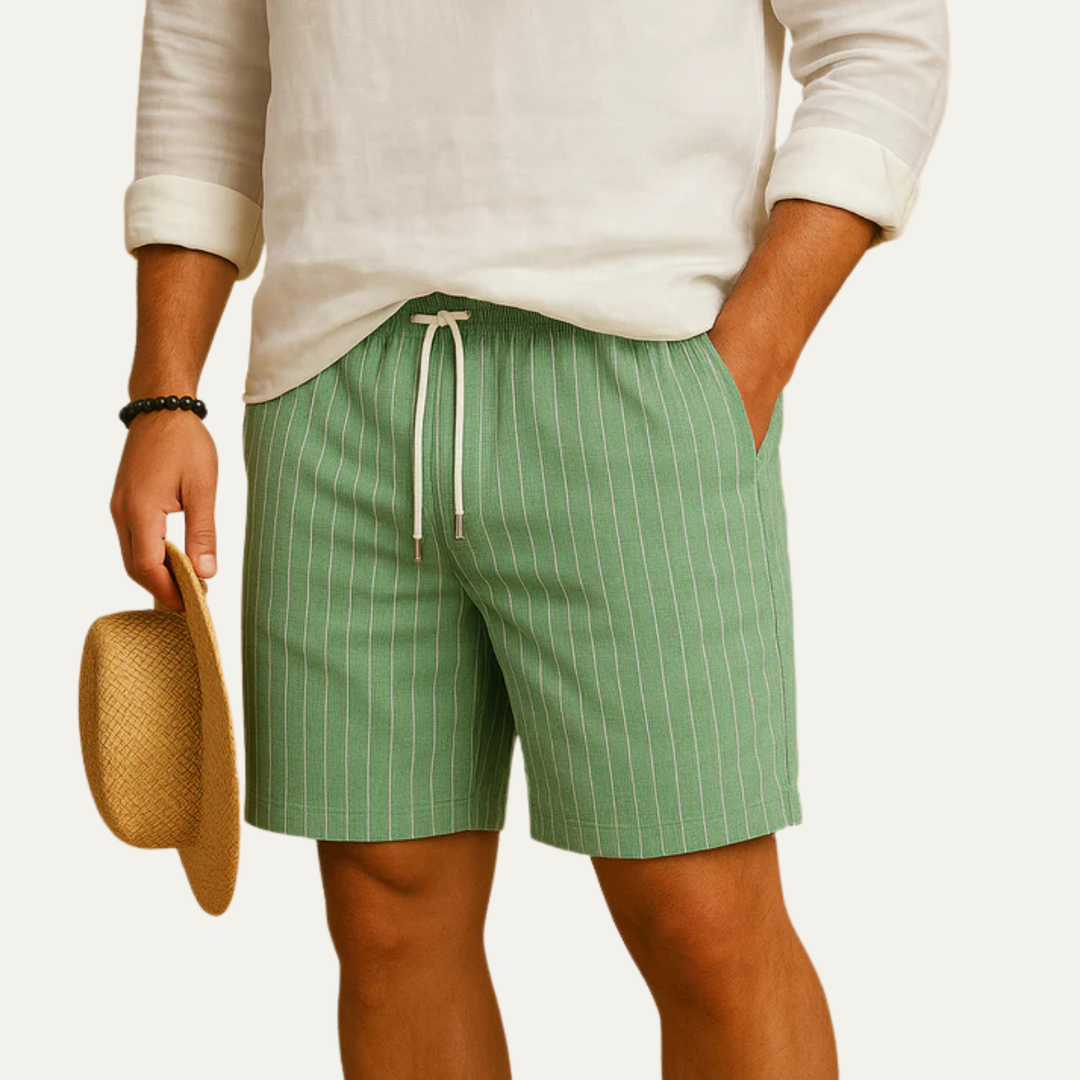 Model wearing green striped drawstring shorts with pockets and casual summer shirt