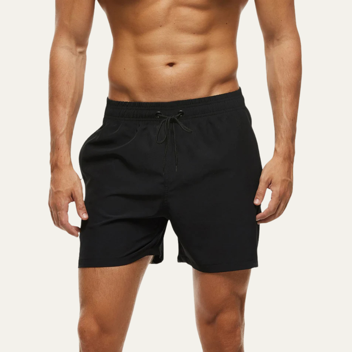 Black swim shorts for men shown on model, mid-length summer bathing suit style