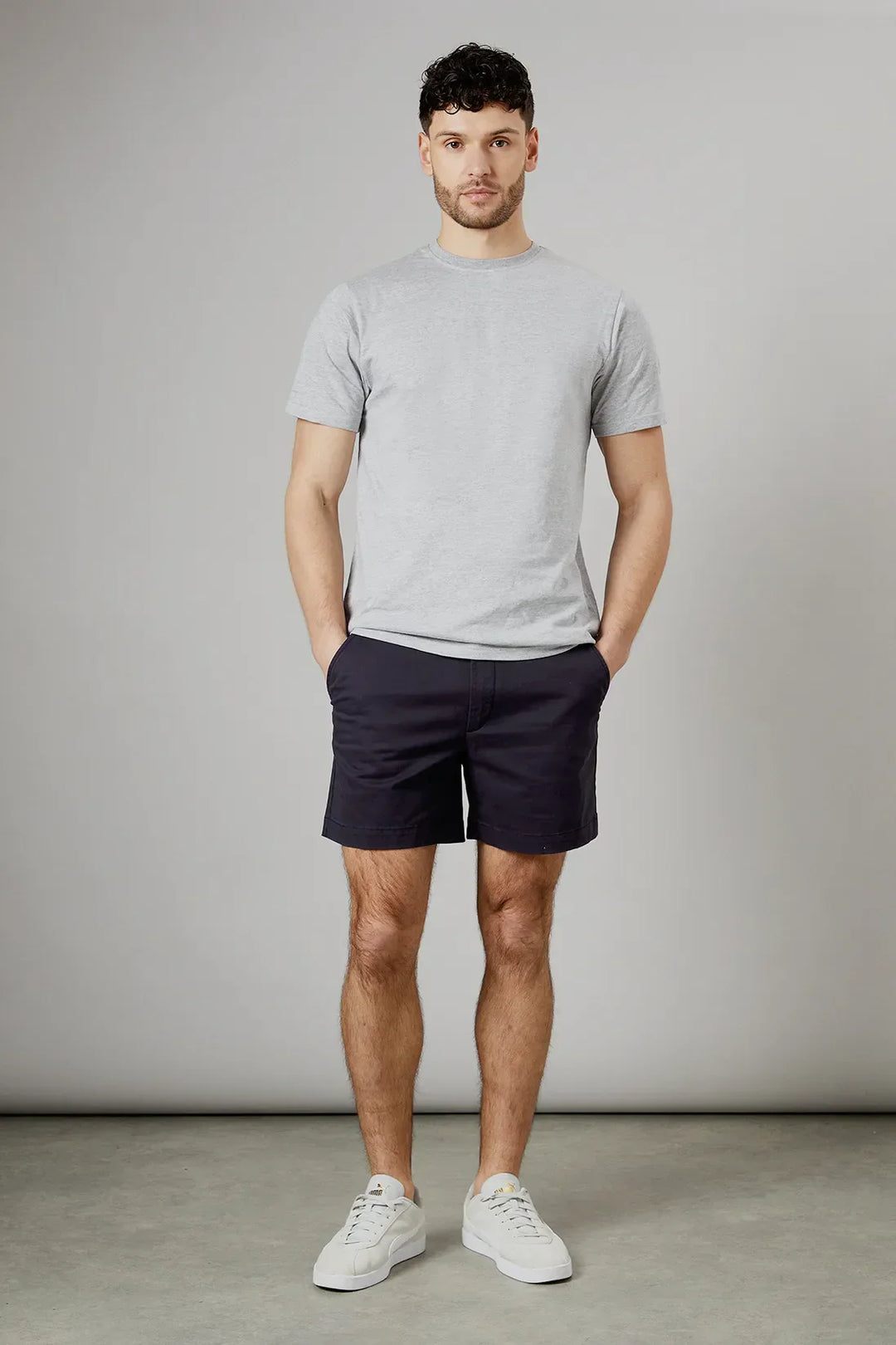 Navy men summer tailored shorts with pockets, front view with cuffed hem and button waist