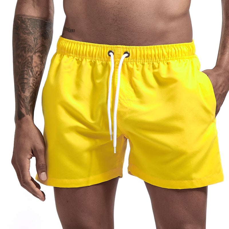 Yellow men swim shorts with elastic waistband, drawstring, and side pocket for swimming