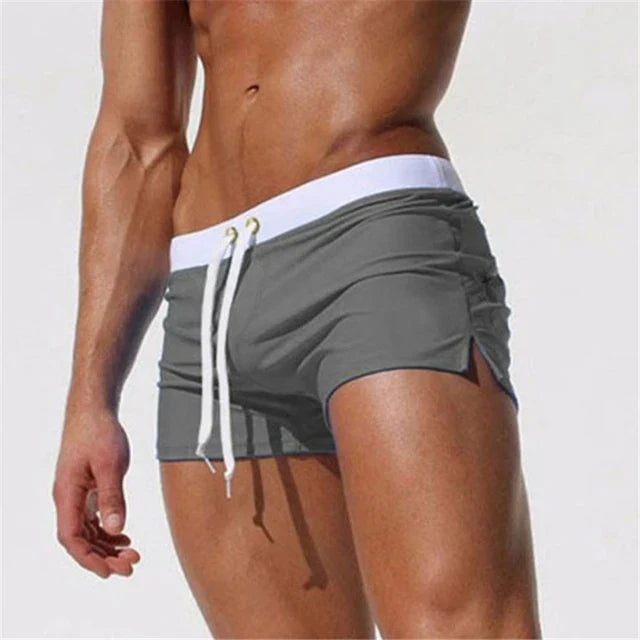Gray men swim shorts with white waistband, drawstring, and side slit cut