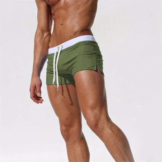 Olive green men swim shorts with white waistband, drawstring, and side slits