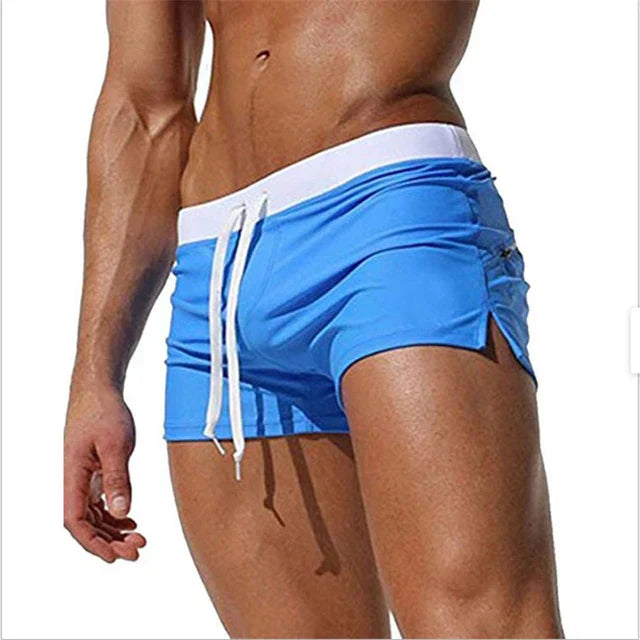 Orange men swim shorts with white waistband and hanging drawstring ties
