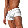 White men swim shorts with drawstring, side slits, and fitted short length