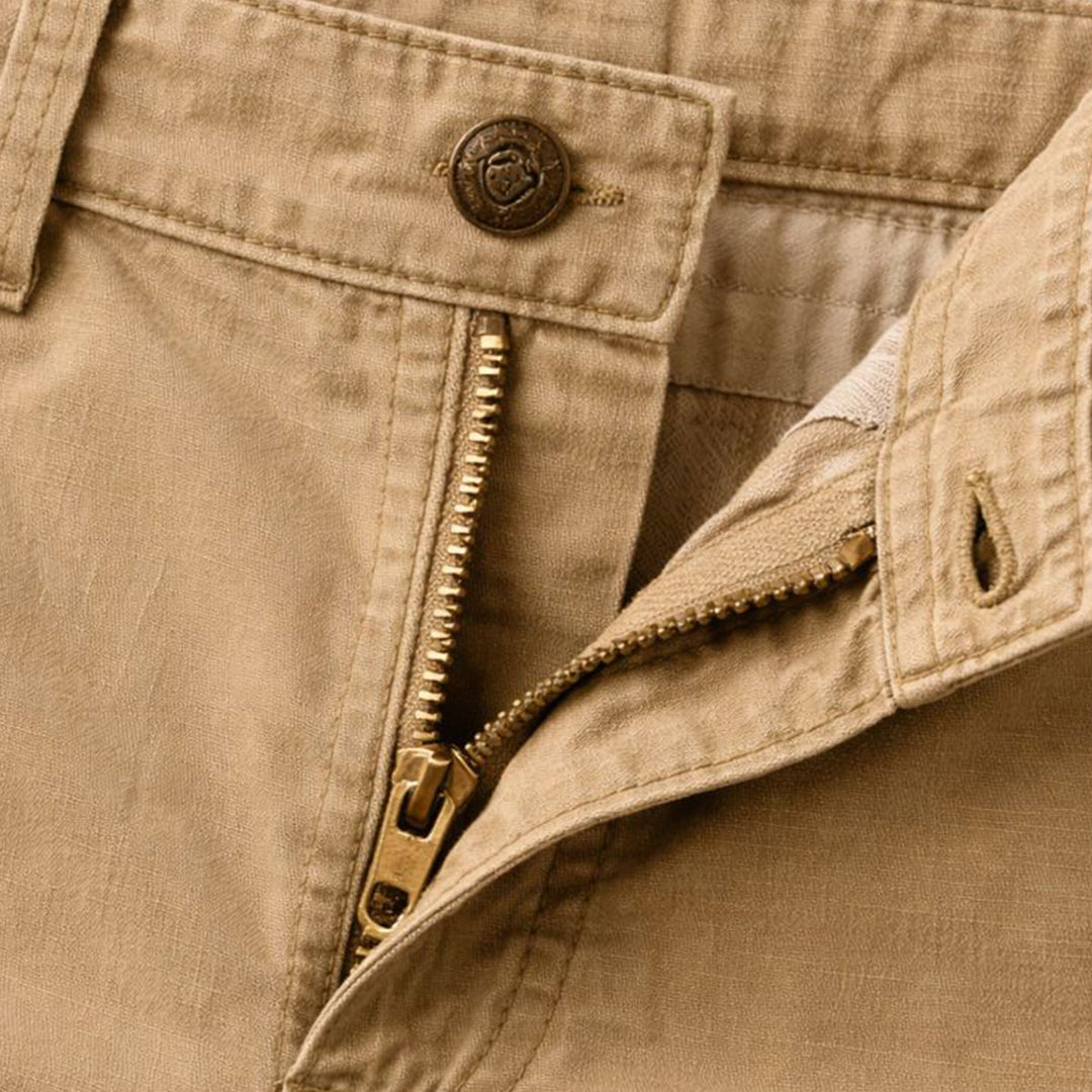 Close-up of khaki cargo shorts waistband and front zipper with button closure