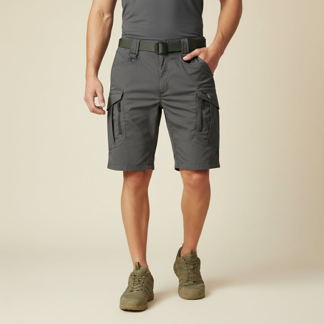 Model wearing dark gray cargo shorts with pockets and olive green belt