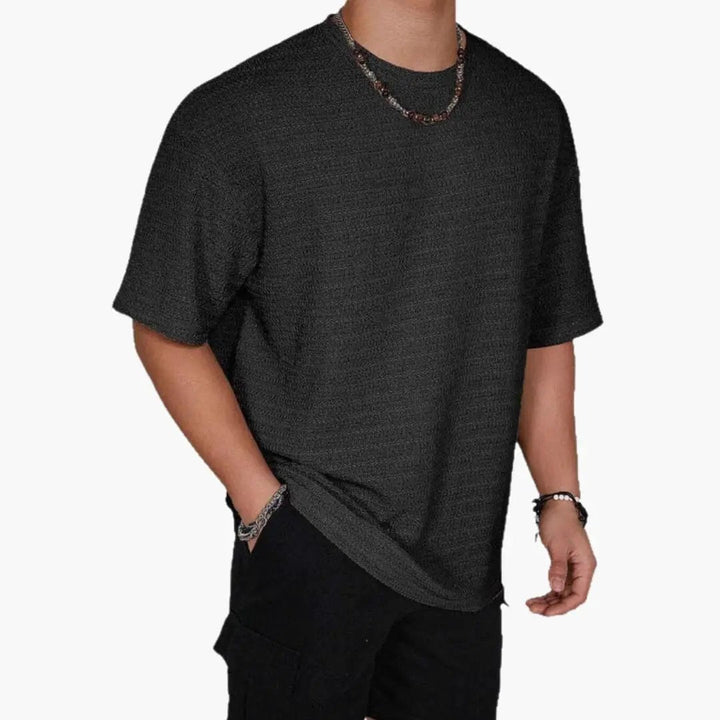 Black textured crew neck short sleeve t-shirt with casual fit and subtle woven pattern