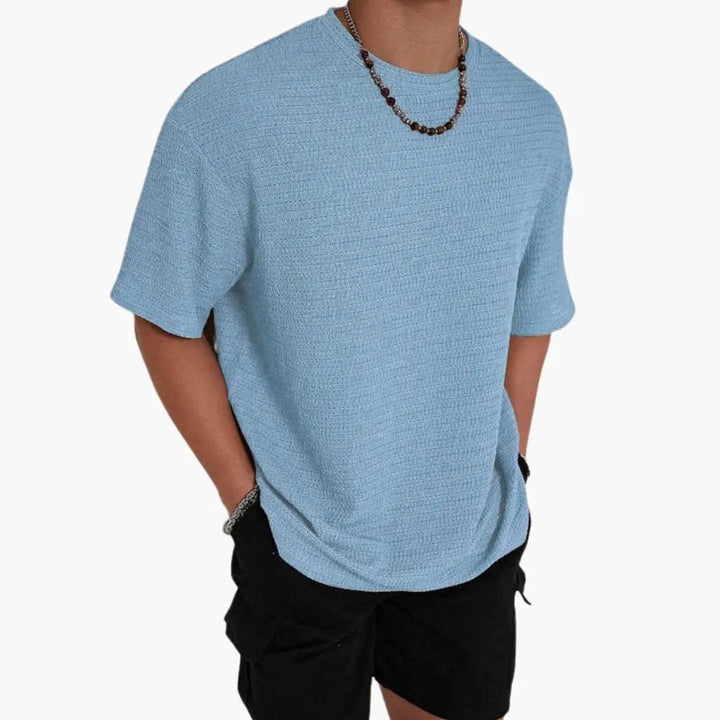 Light blue textured crew neck short sleeve t-shirt styled with black shorts