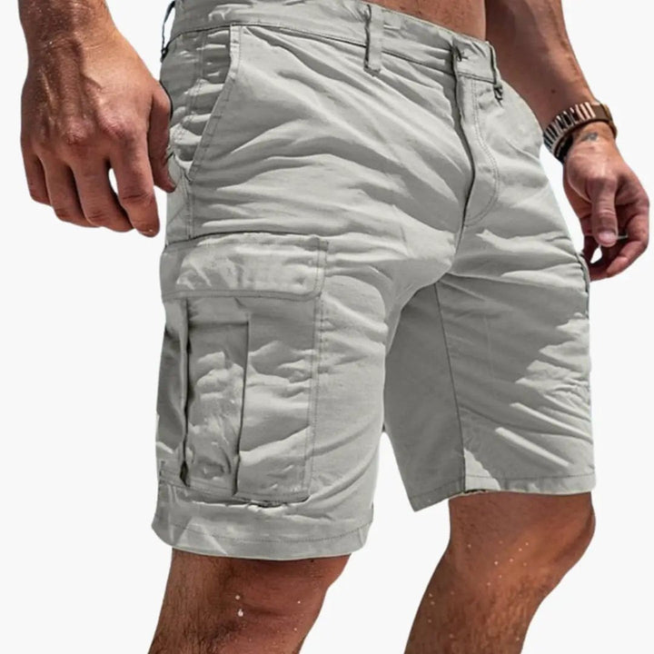 Light gray men's cargo knee length shorts with side flap pockets and zipper pocket