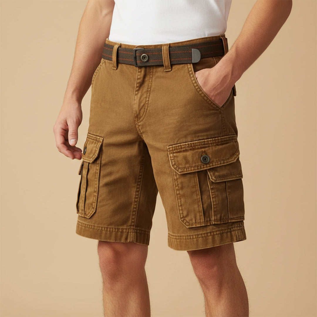 Model wearing tan utility cargo shorts with belt and front pocket detail, casual workwear shorts