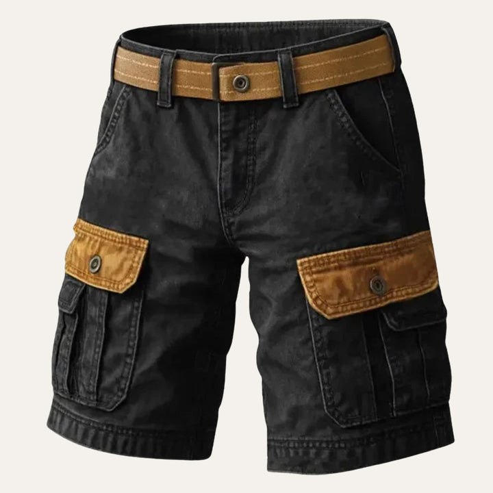 Close-up of tan men's cargo shorts leg pocket with flap closure and durable workwear fabric