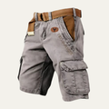 Side angle of gray cargo shorts with belt, showing large flap pocket and relaxed fit