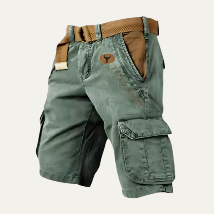 Green men's cargo shorts with belt, angled view with utility pocket and stitched details