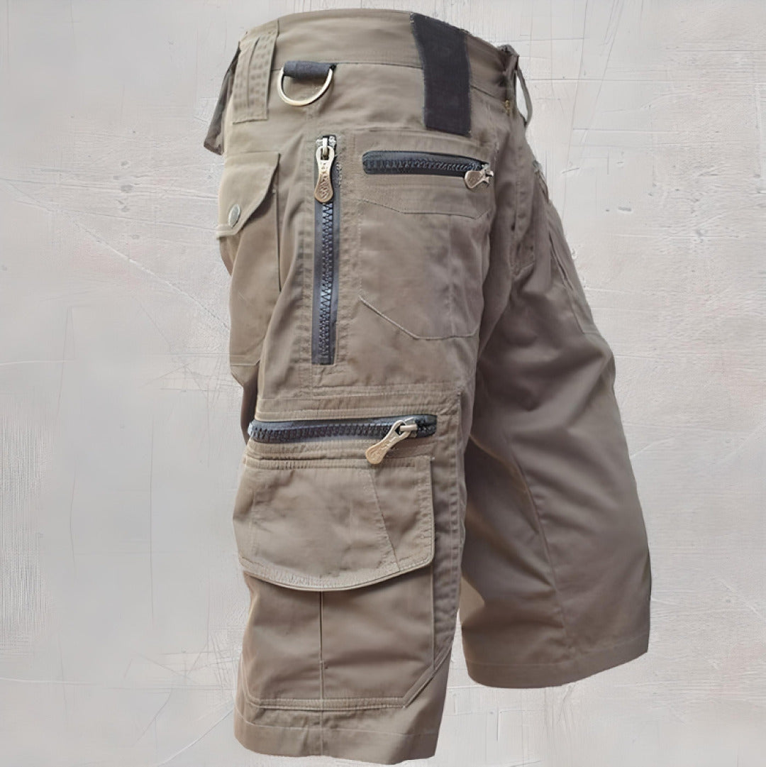 Khaki knee length cargo shorts with zip pockets and utility D-ring accent