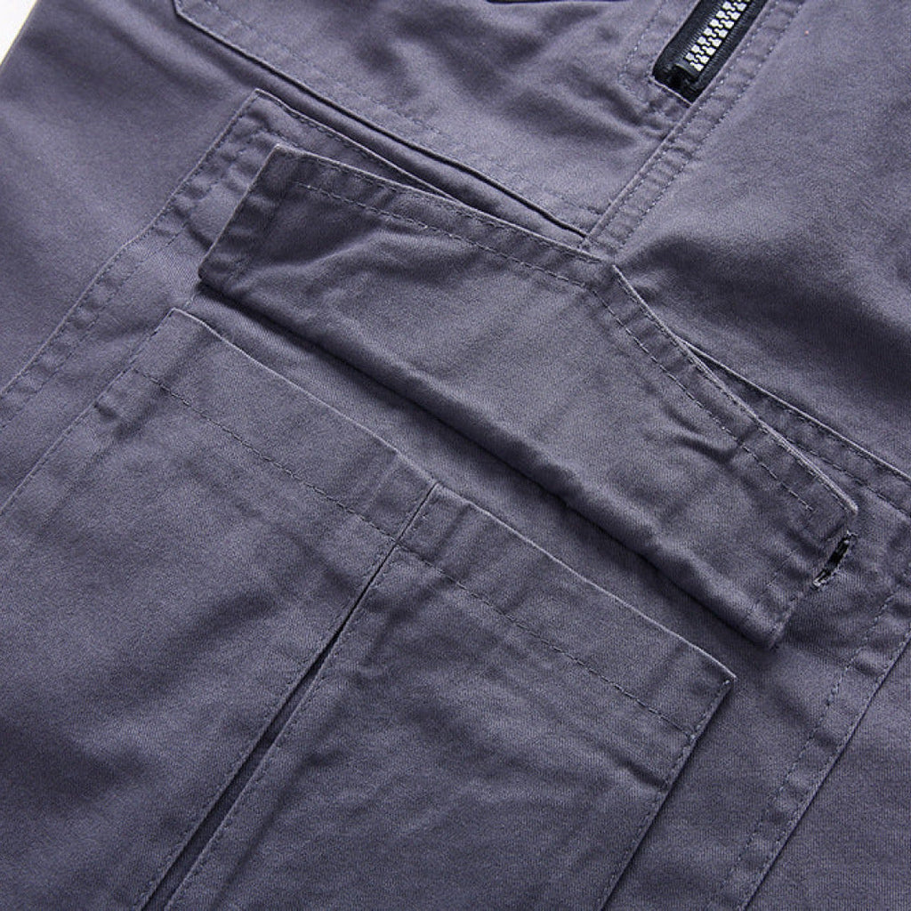 Close-up of dark gray cargo shorts showing layered pocket design and stitching