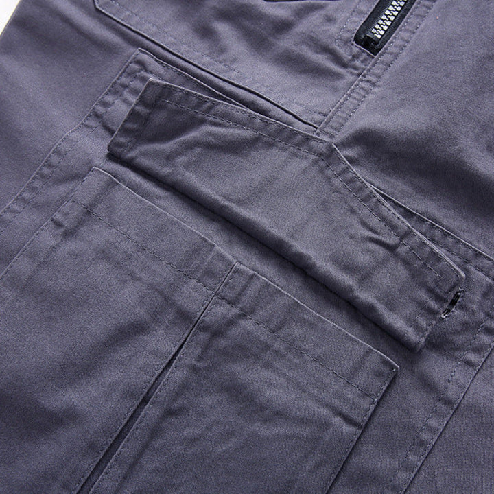 Close-up of dark gray cargo shorts showing layered pocket design and stitching
