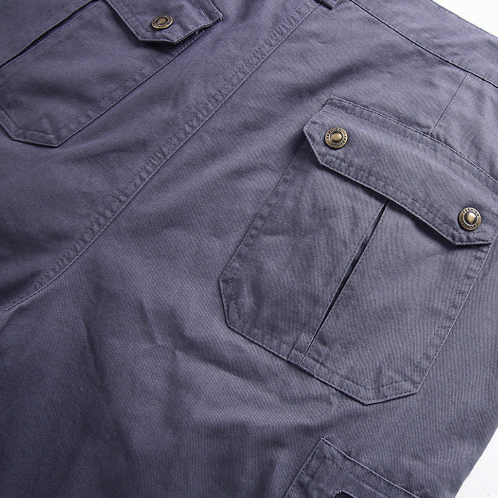 Close-up of gray cargo shorts with flap pockets and snap button cargo details