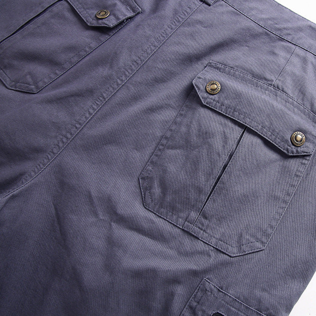 Close-up of gray cargo shorts with flap pockets and snap button cargo details