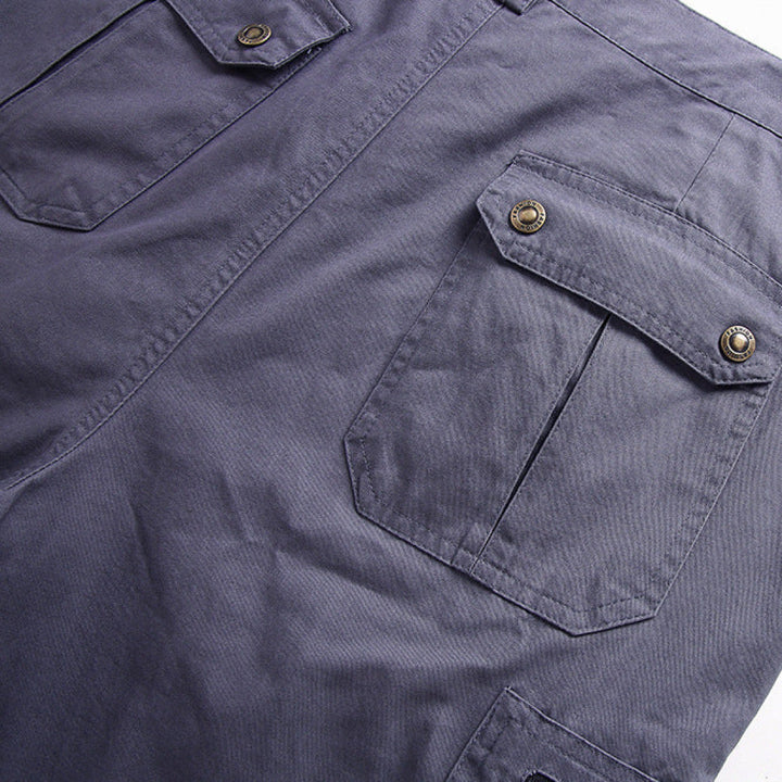 Close-up of gray cargo shorts with flap pockets and snap button cargo details