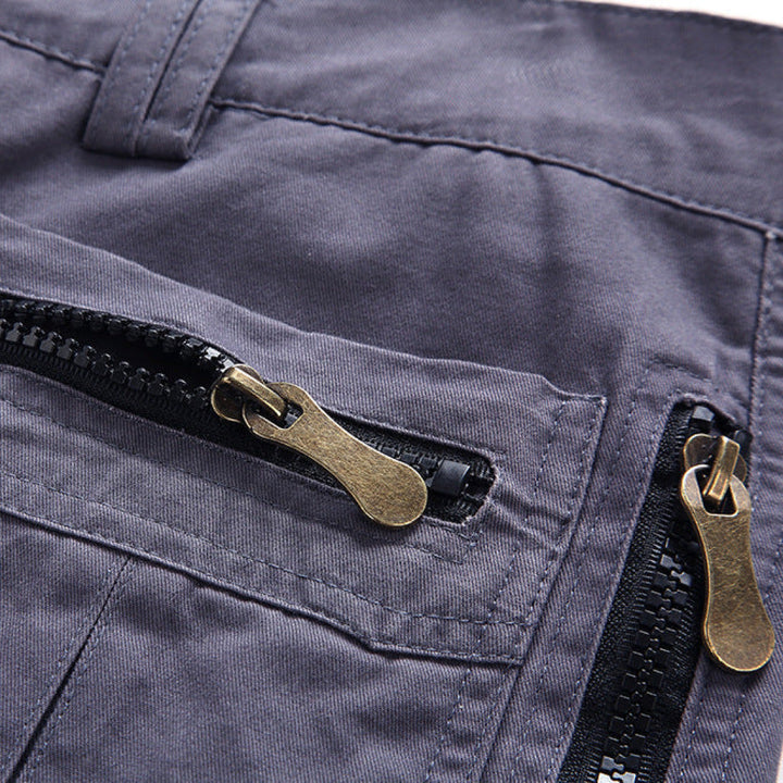 Close-up of zip pocket cargo shorts with brass zipper pulls and utility pocket