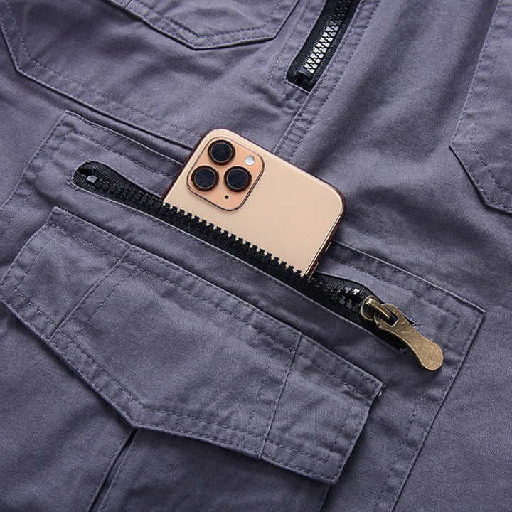 Gray cargo shorts pocket detail with zip closure and phone-sized storage pocket