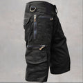 Black knee length cargo shorts with multiple zip pockets and D-ring detail