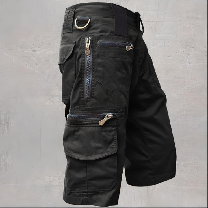 Black knee length cargo shorts with multiple zip pockets and D-ring detail