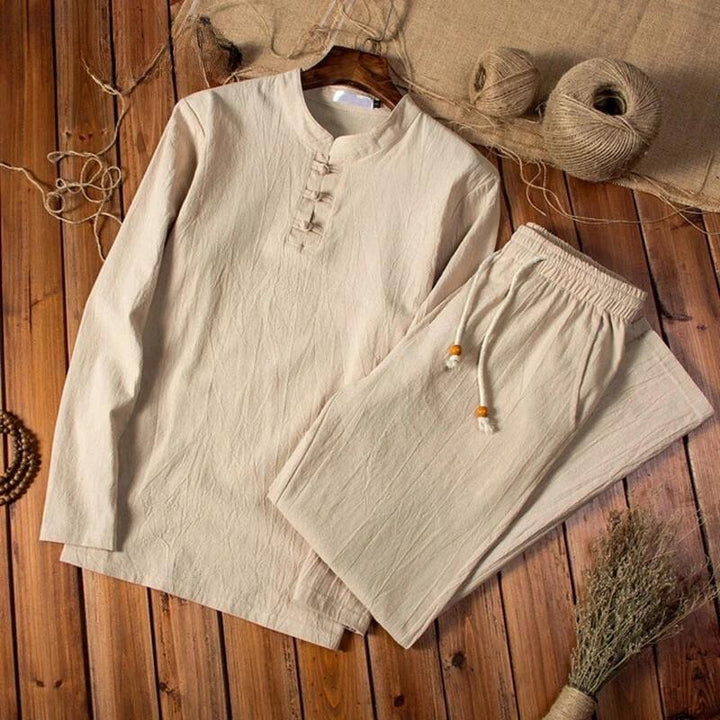 Beige men's linen blend long sleeve shirt and drawstring pants set on wooden floor