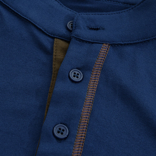 Close-up of navy Henley shirt collar, button placket, and contrast seam detail