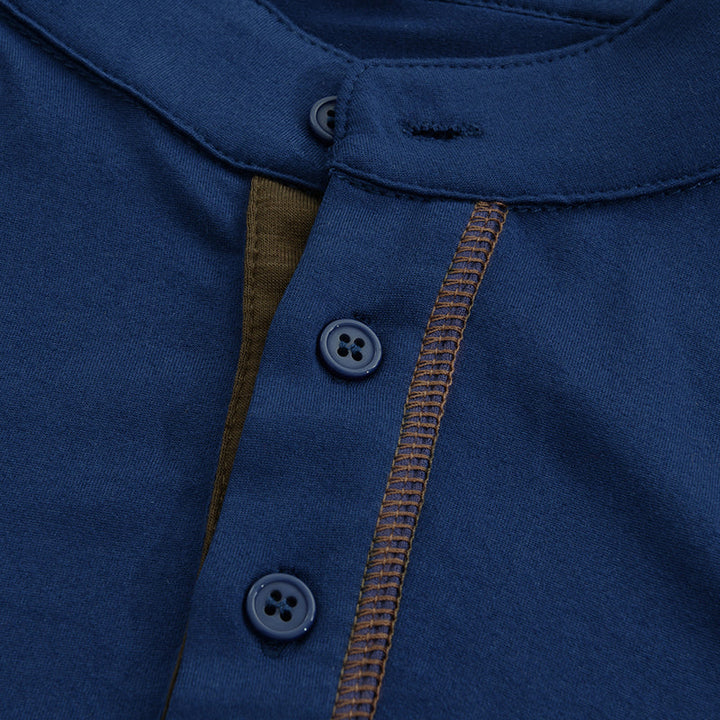 Close-up of navy Henley shirt collar, button placket, and contrast seam detail