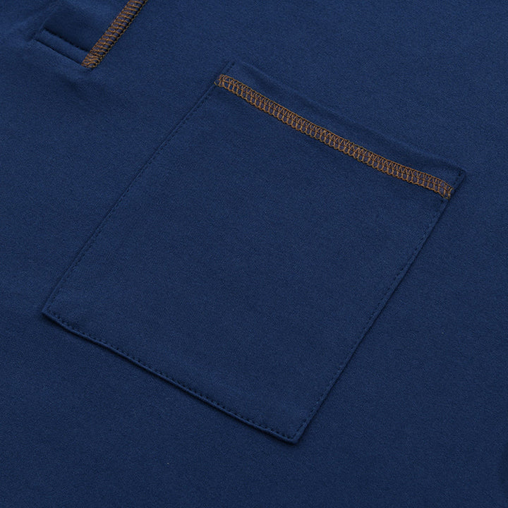 Close-up of navy casual shirt chest pocket with contrast top stitching and soft knit fabric