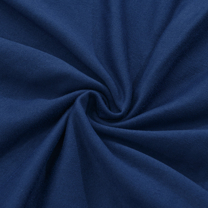 Close-up of navy shirt fabric texture showing a smooth knit surface with gathered folds